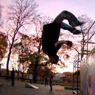 Freerunner doing a somersault in the skatepark