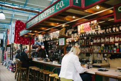 Customers sat at an indoor market coffee shop